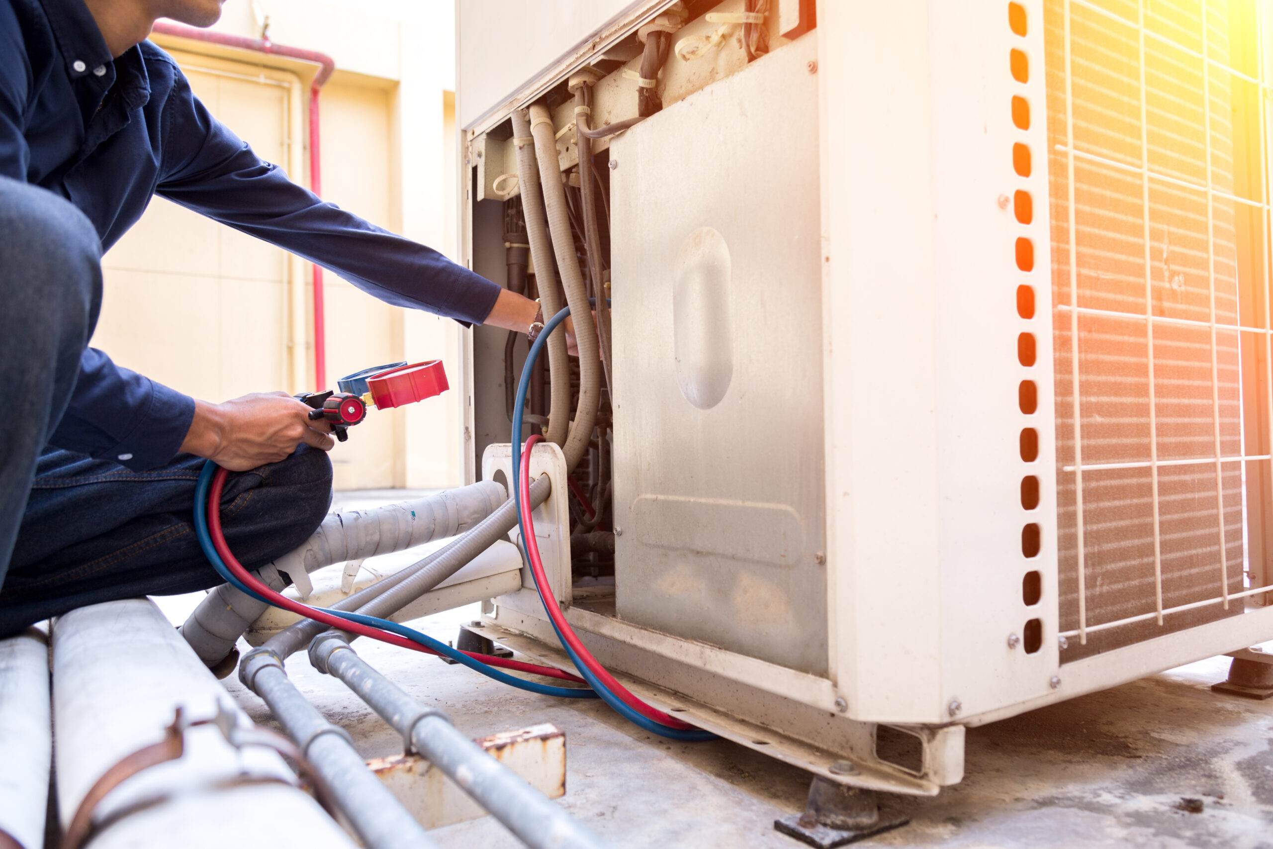 Technician is checking air conditioner ,measuring equipment for